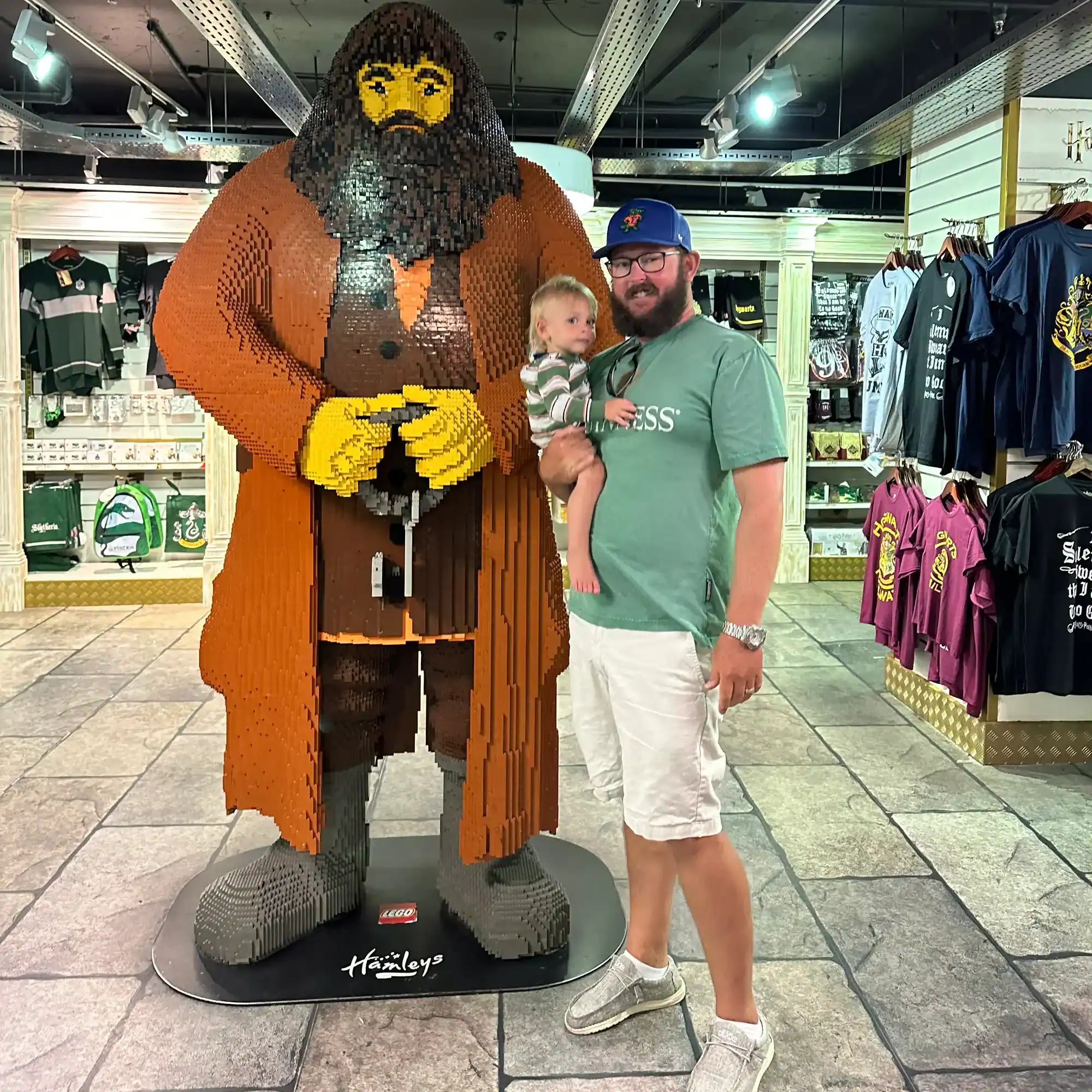 my husband and son with a giant lego hagrid at Hamley's toy store in London