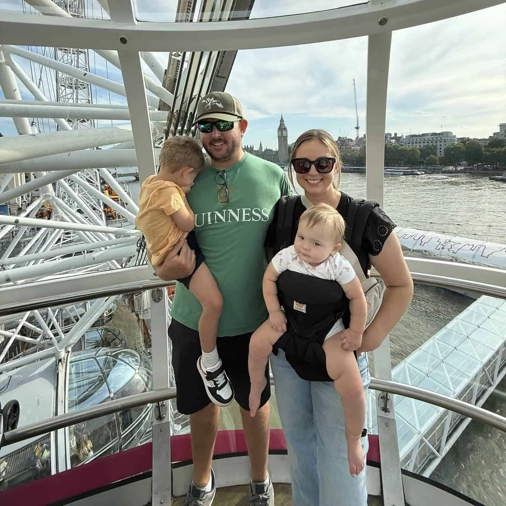 my husband and our two toddlers on the london eye in london