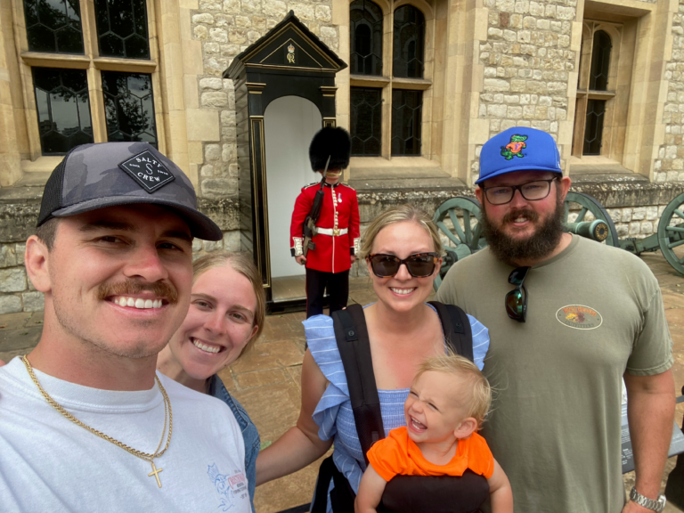 my family at the tower of london on a family london travel trip posing with beefeater
