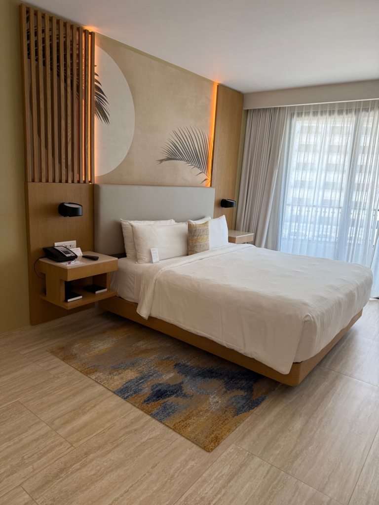 Marriott All Inclusive Resort King Bed room, looking into the room with balcony in background