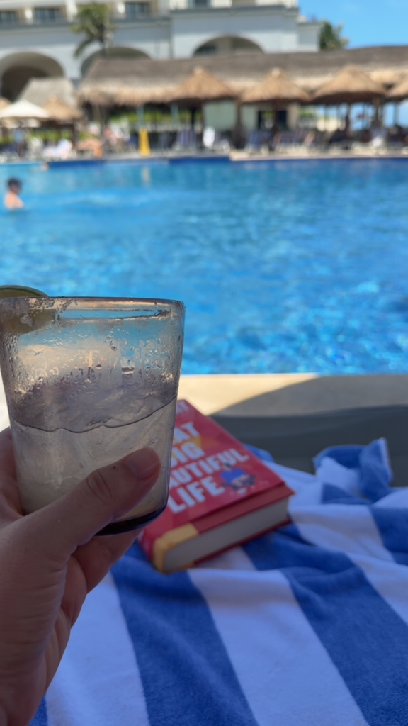 Sitting at the pool with a margarita and book at the bar at Marriott Cancun Resort