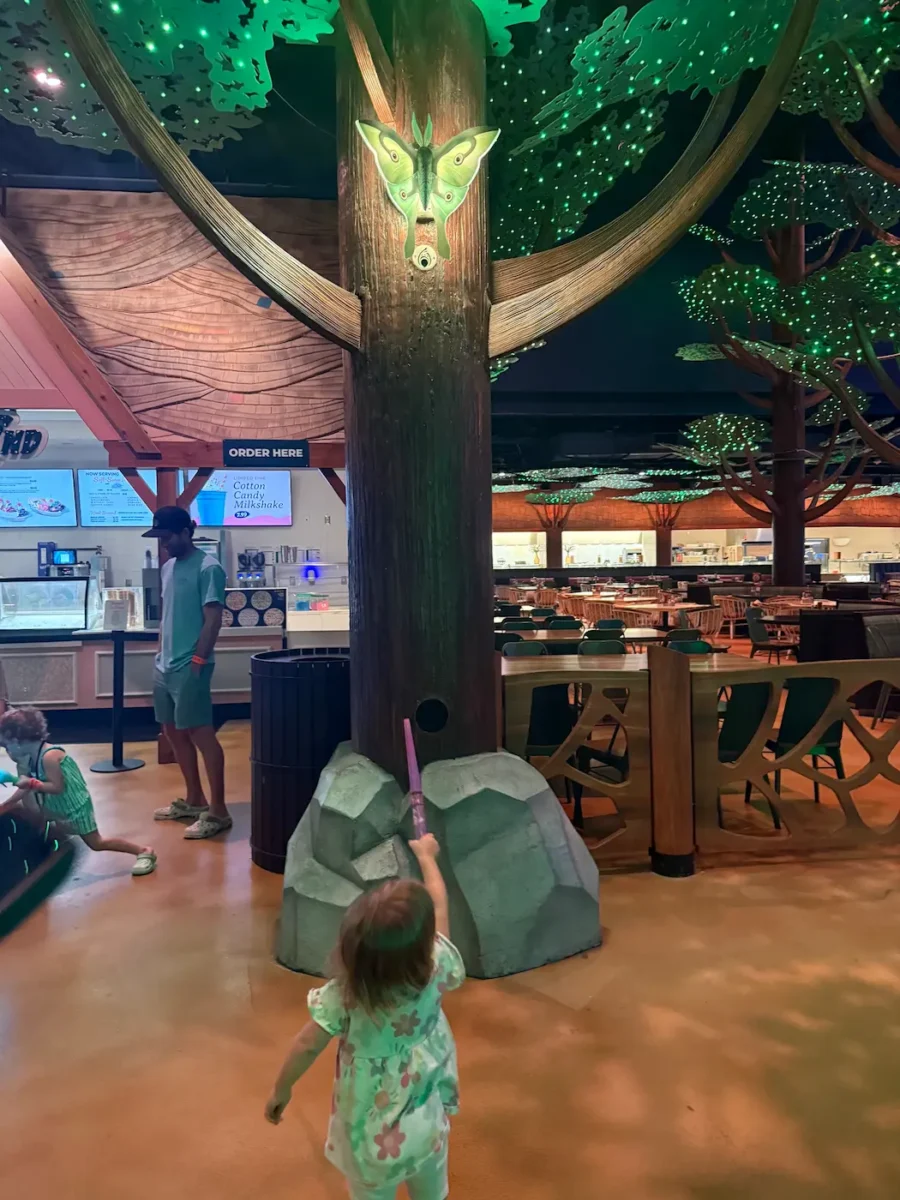 My daughter pointing her wand at a butterfly during the Magiquest game at Great Wolf Lodge.