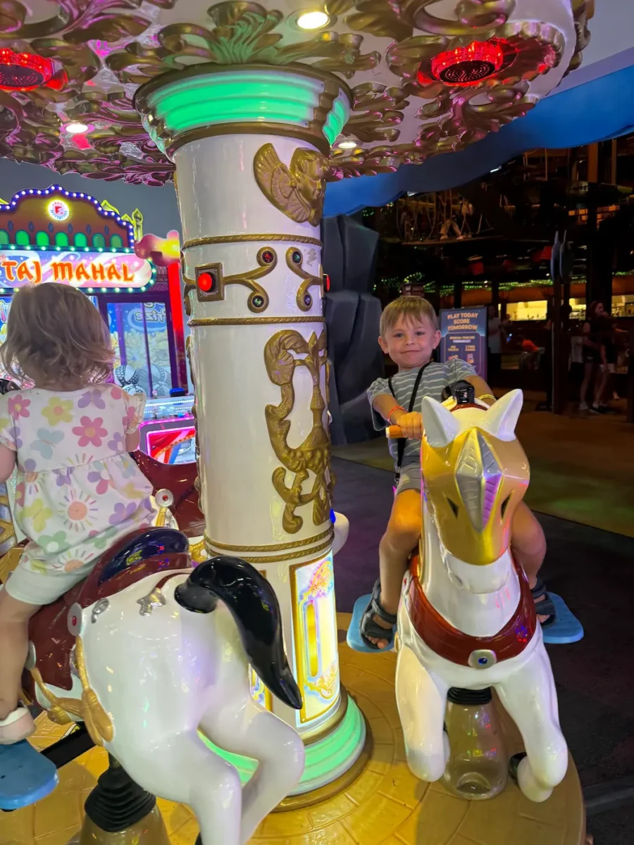 My kids on a merry go round in the arcade at Great Wolf Lodge in Naples.