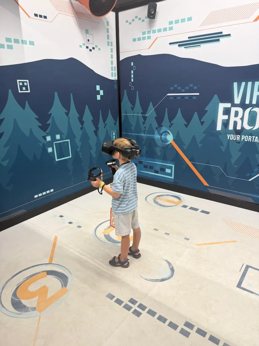 My son playing a VR game - Dinosaur Island - at Great Wolf Lodge in Naples.