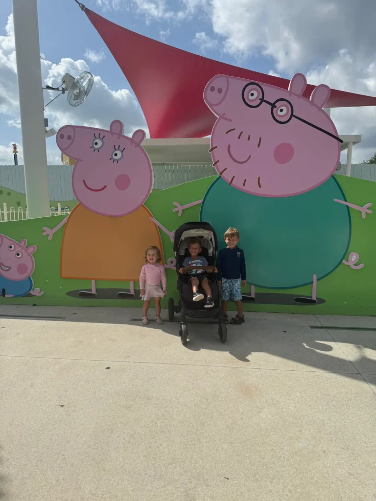 My toddlers and nephew outside the entrance of Peppa Pig World