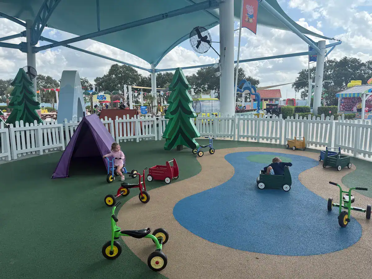 My kids playing on the bikes on the toddler bike path at Peppa Pig World