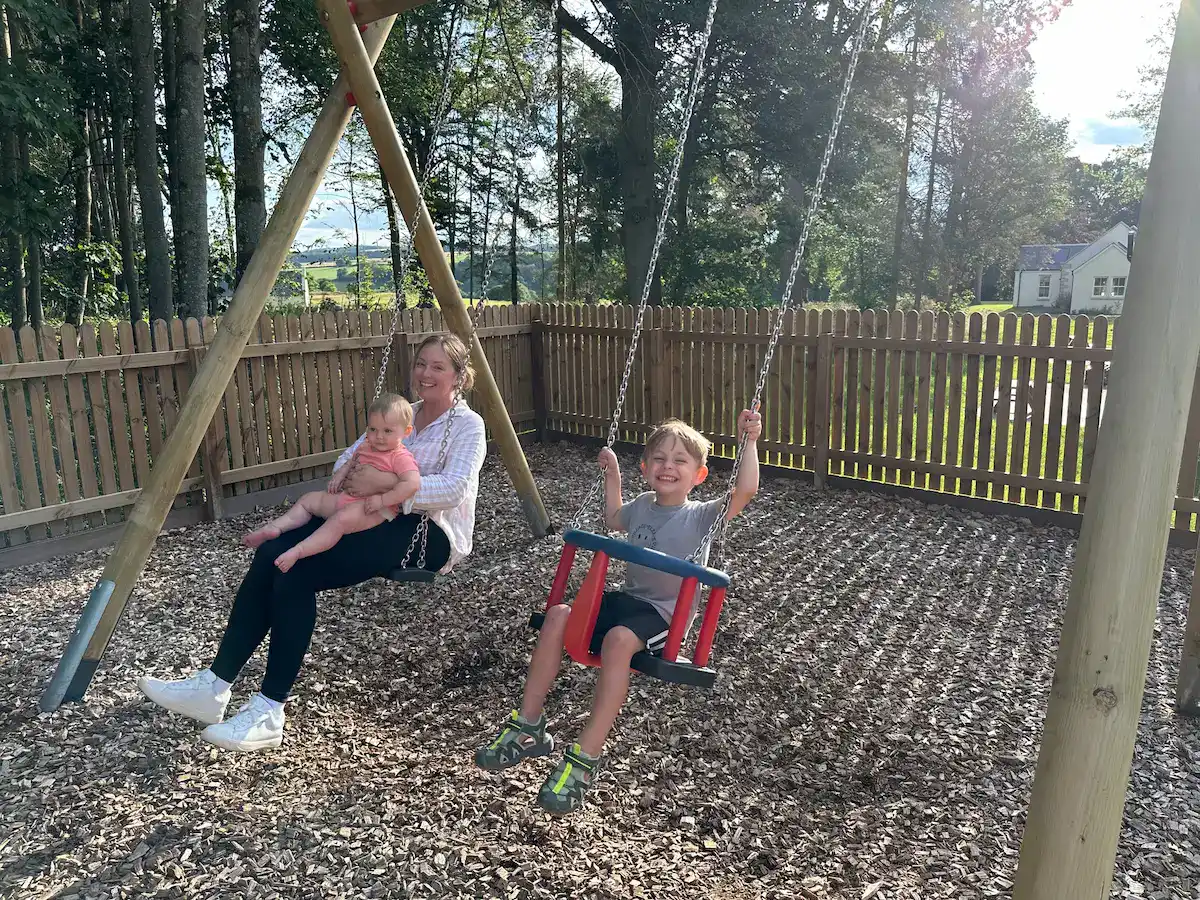swinging on the swings at the kids club playground at schloss roxburghe
