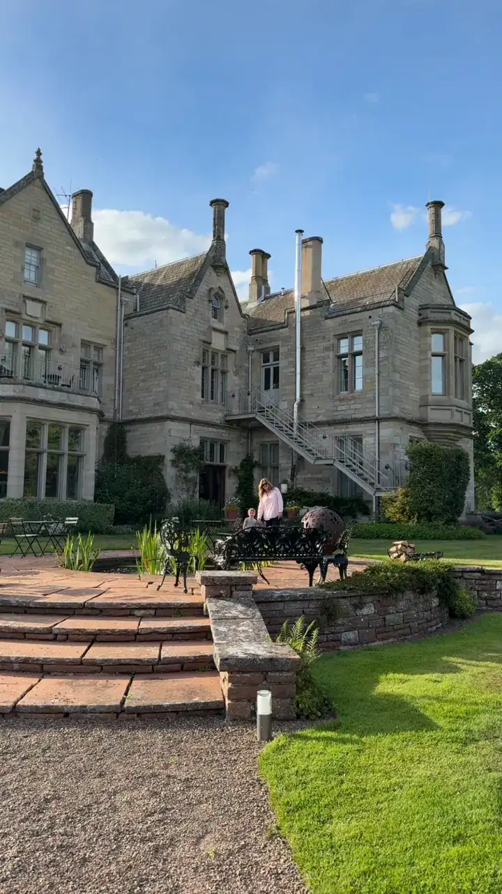 My mom and son standing in front of Schloss Roxburghe in The Scottish Borders