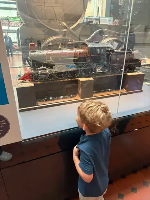 My son looking at a train at the National Museum of Scotland